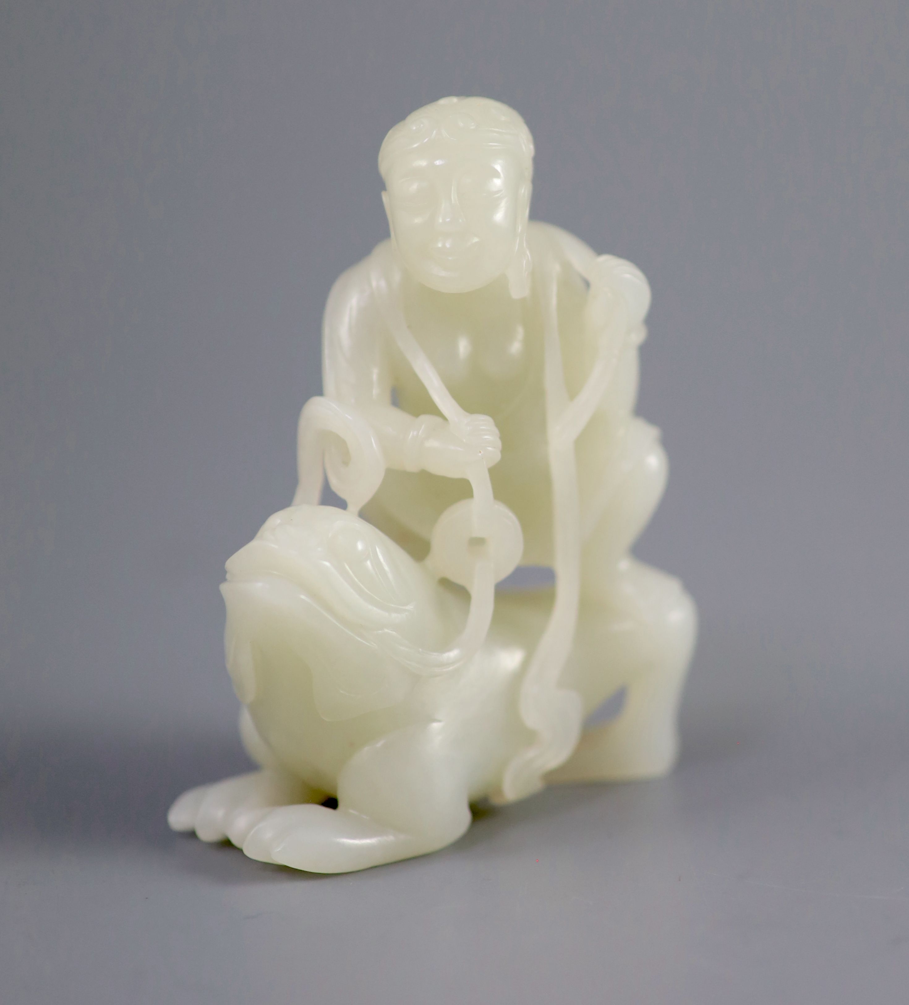 A good Chinese pale celadon jade group of Liu Hai and the three legged toad, 18th century, 8cm high, the wood stand carved with swirling waves